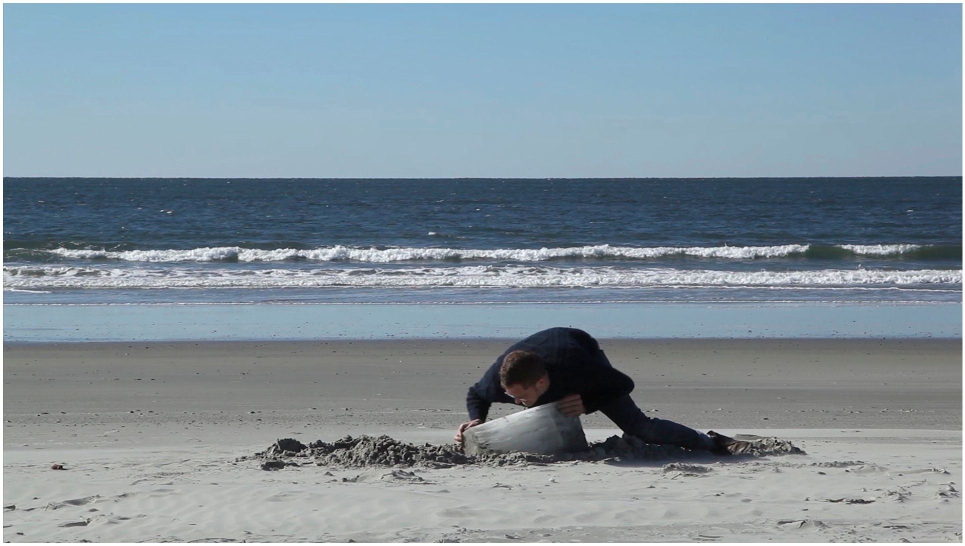 The Foolish Builder, 2012  video and performance  Over the course of a week, I poured water into a box that I had placed into my freezer, allowing it to form into a solid block of ice. I then drove  down to the ocean, and with my back to the Atlantic, buried it in the  sand by pushing it back and forth.