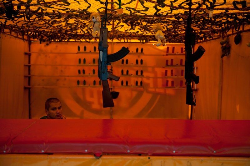 Fairground worker with machine guns, Ukraine, 2012